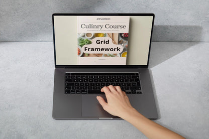 Laptop displaying a culinary course on a gray surface with a hand interacting with it.