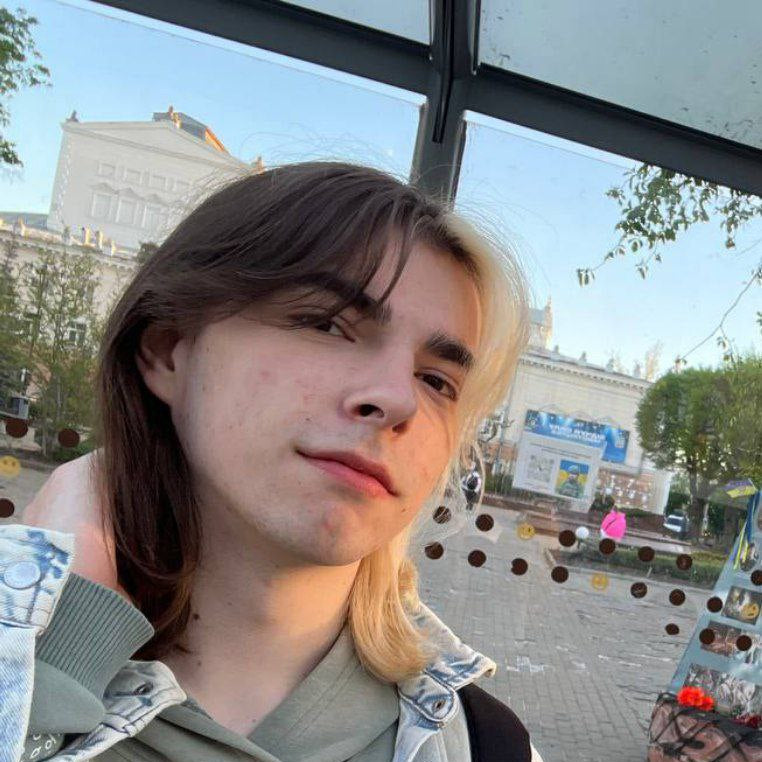 Tomasz Sienkiewicz standing outdoors with a blurred background