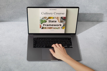 Laptop displaying a culinary course on a gray surface with a hand interacting with it.
